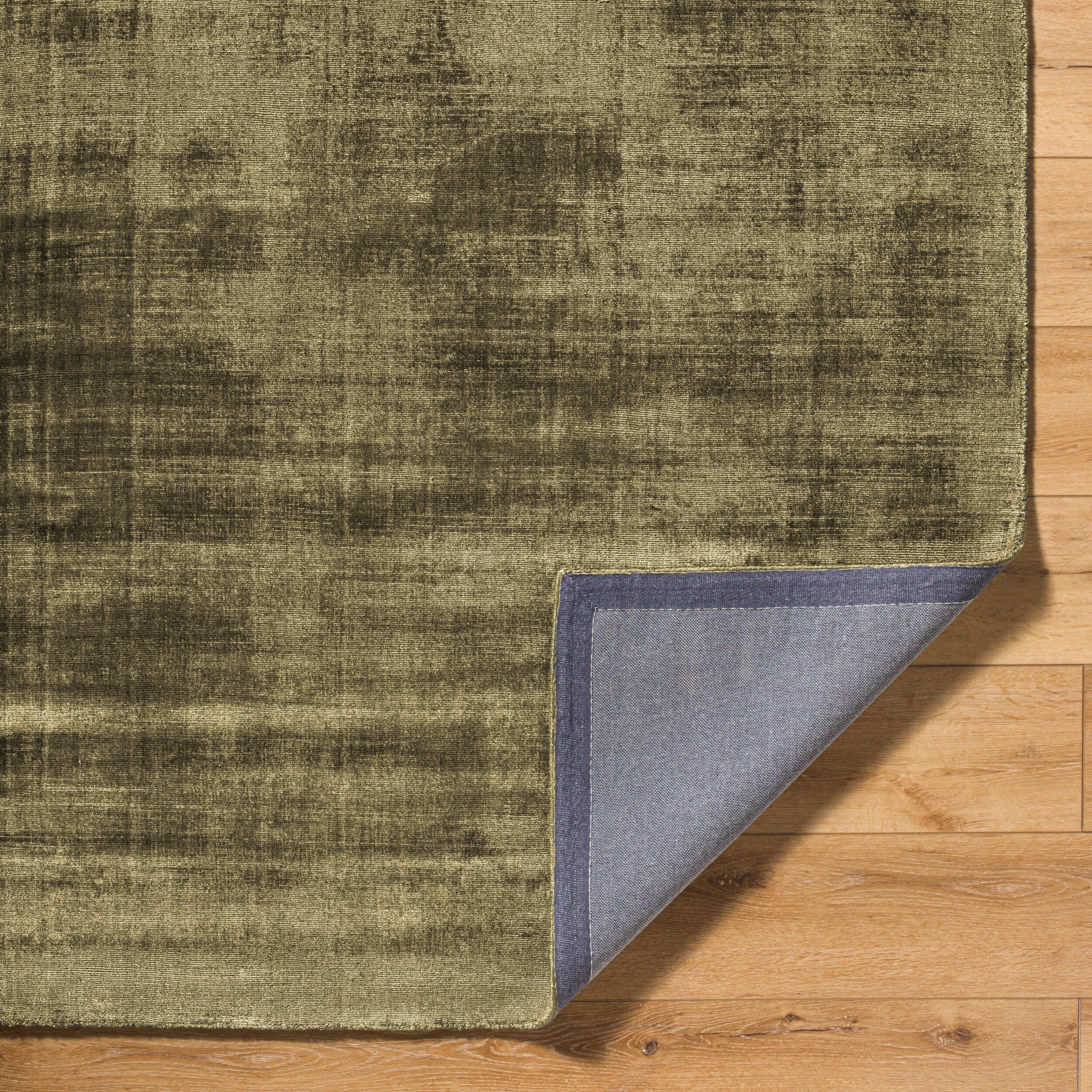 Distressed gold and charcoal textured area rug with abstract worn finish