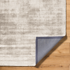 Cream and grey distressed textured rug with mottled abstract pattern