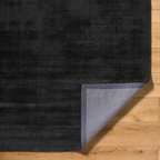 Dark charcoal grey distressed wool rug with subtle texture pattern