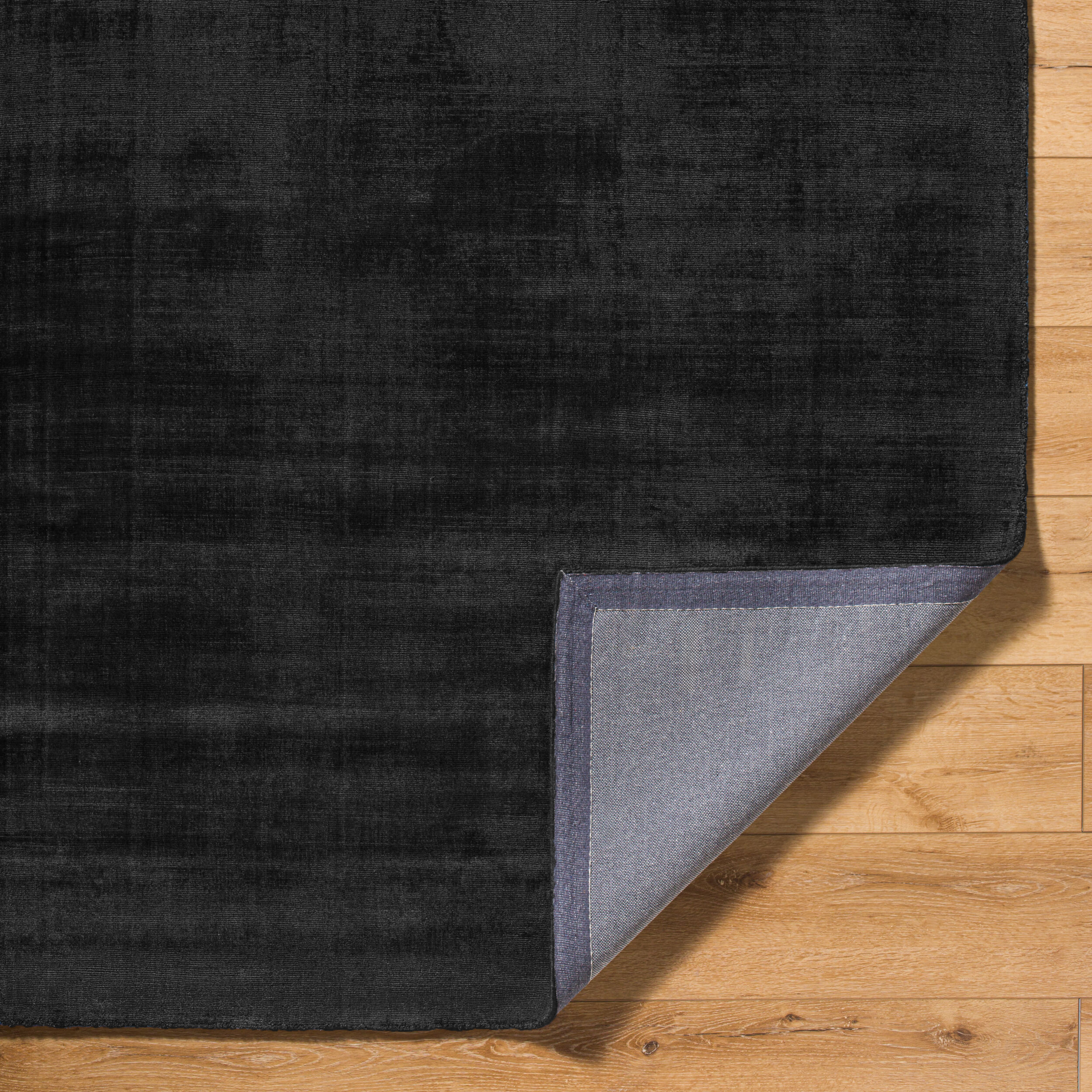 Dark charcoal grey distressed wool rug with subtle texture pattern