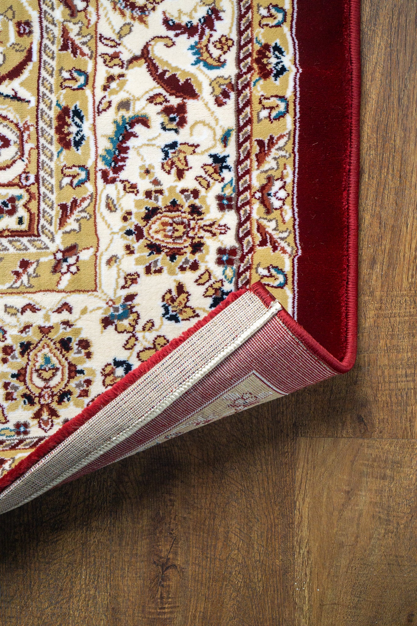 Burgundy traditional rug with ornate gold and cream floral medallion pattern