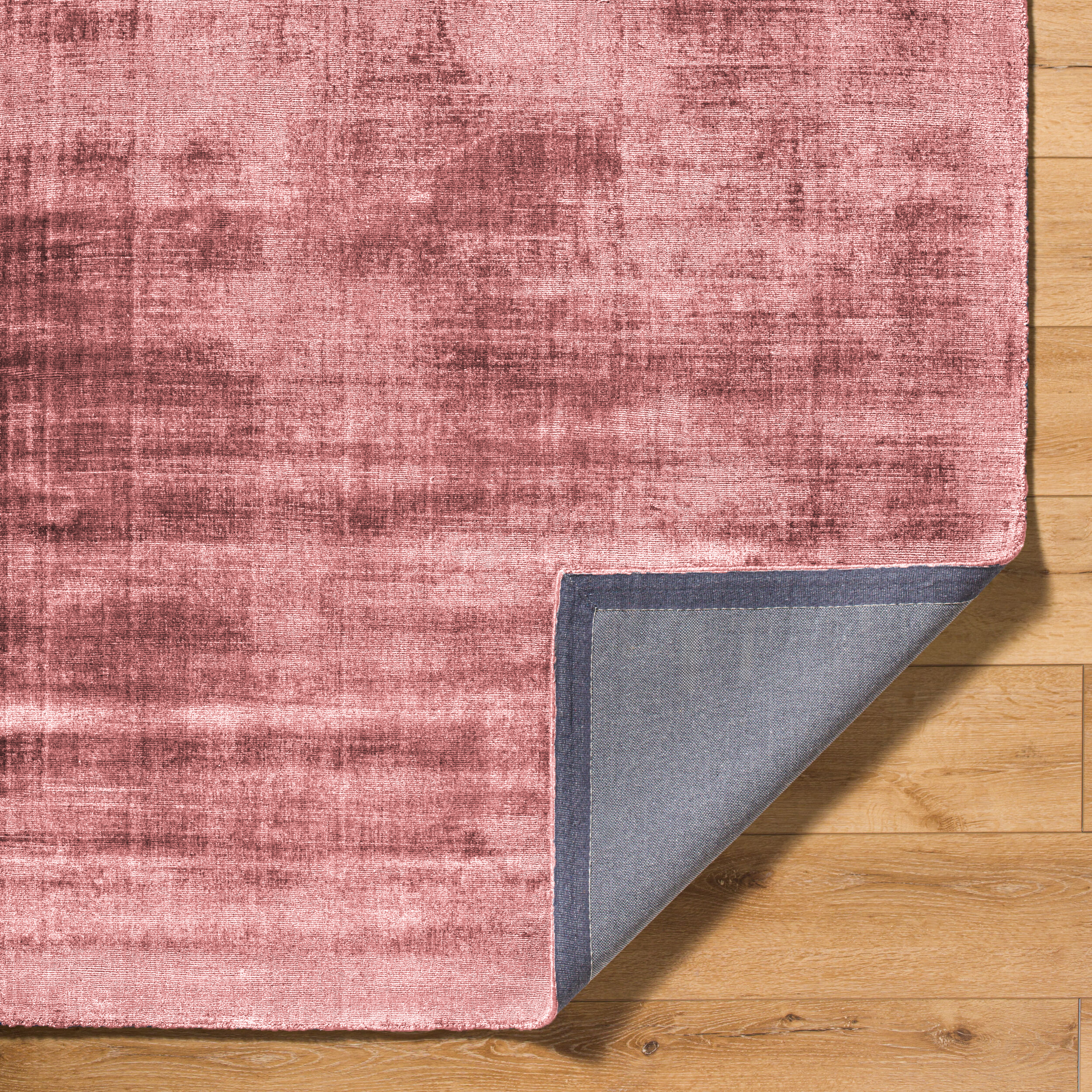 Modern distressed pink area rug with textured abstract pattern
