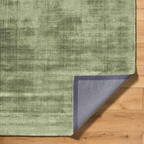 Sage green distressed texture area rug with mottled vintage appearance