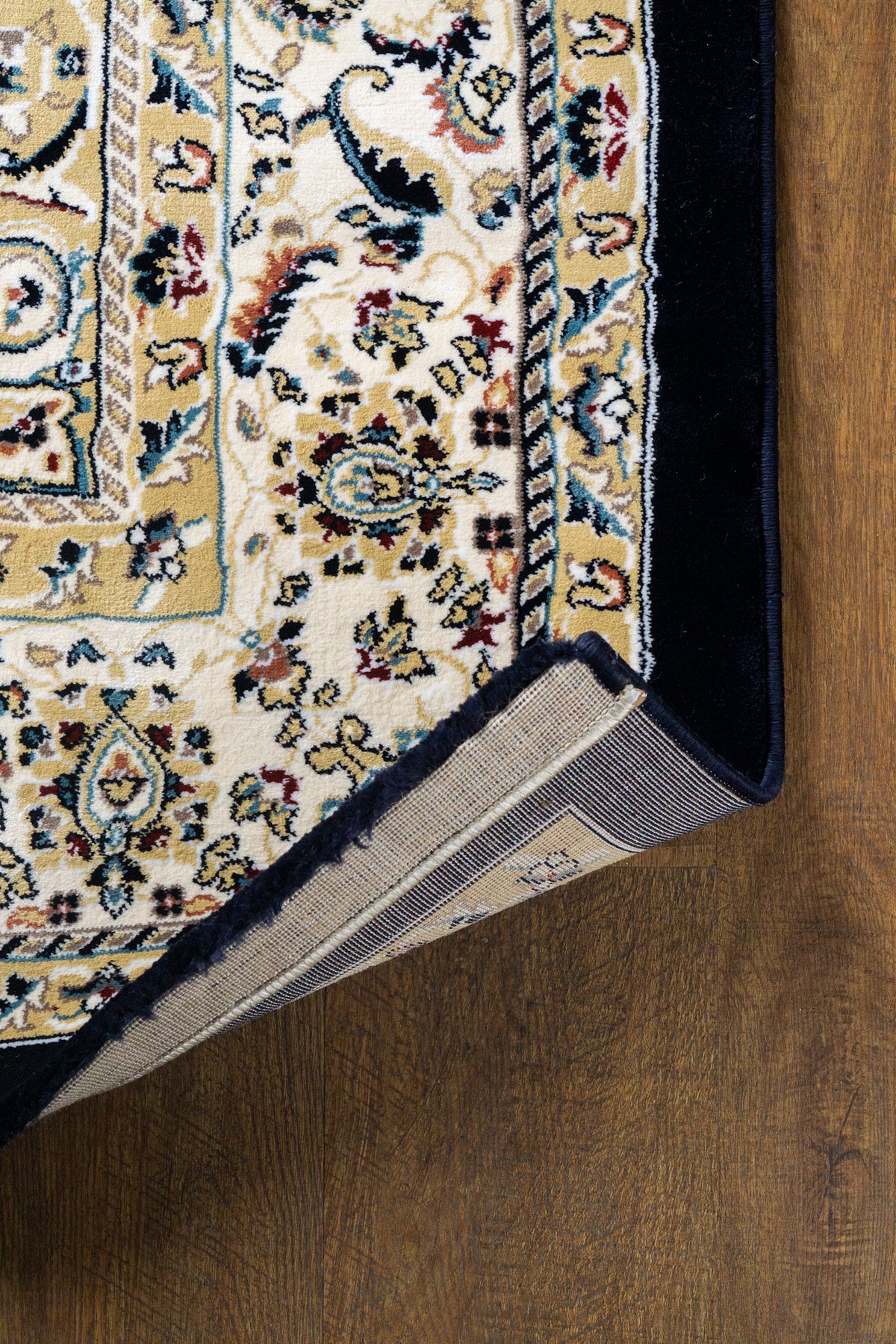 Black and gold traditional Persian style rug with ornate medallion pattern