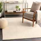 Cream colored wool rug with subtle woven texture and natural fibers
