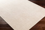 Cream textured wool area rug with natural woven pattern and soft neutral tone