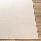 Cream textured wool area rug with natural woven pattern and soft neutral tone