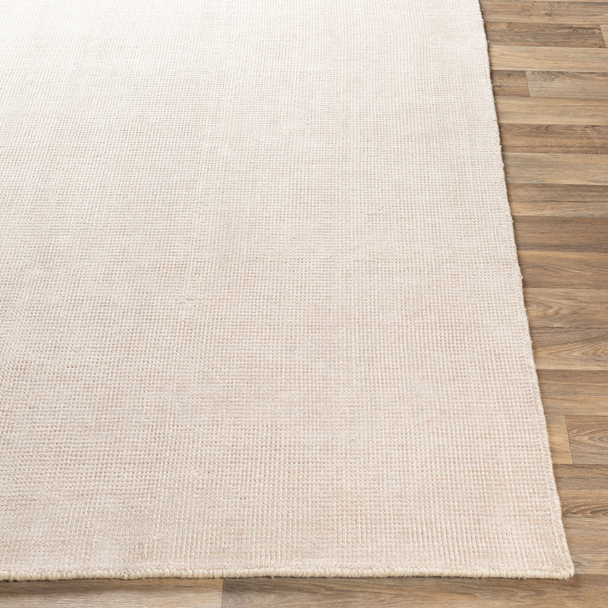 Cream textured wool area rug with natural woven pattern and soft neutral tone