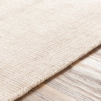 Cream textured wool area rug with natural woven pattern and soft neutral tone