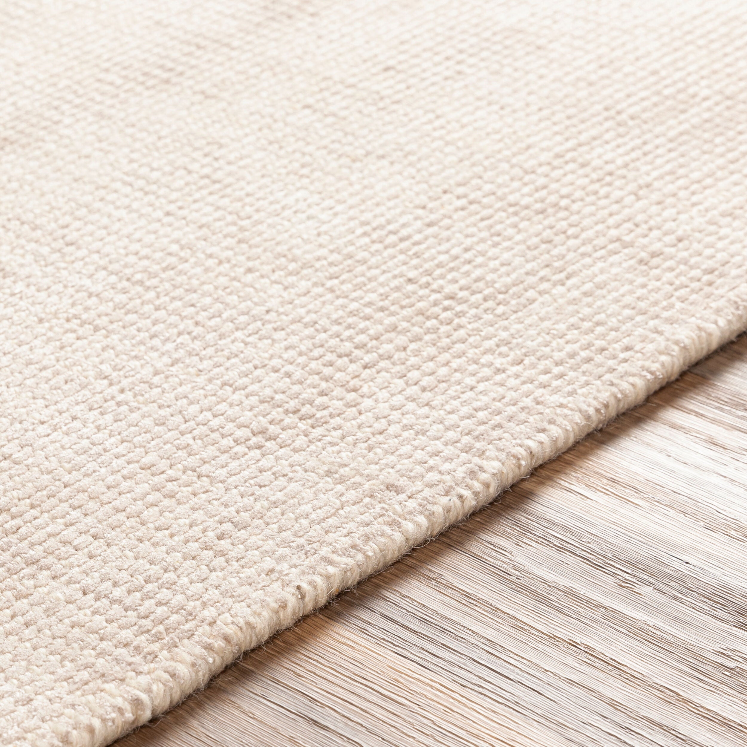 Cream textured wool area rug with natural woven pattern and soft neutral tone