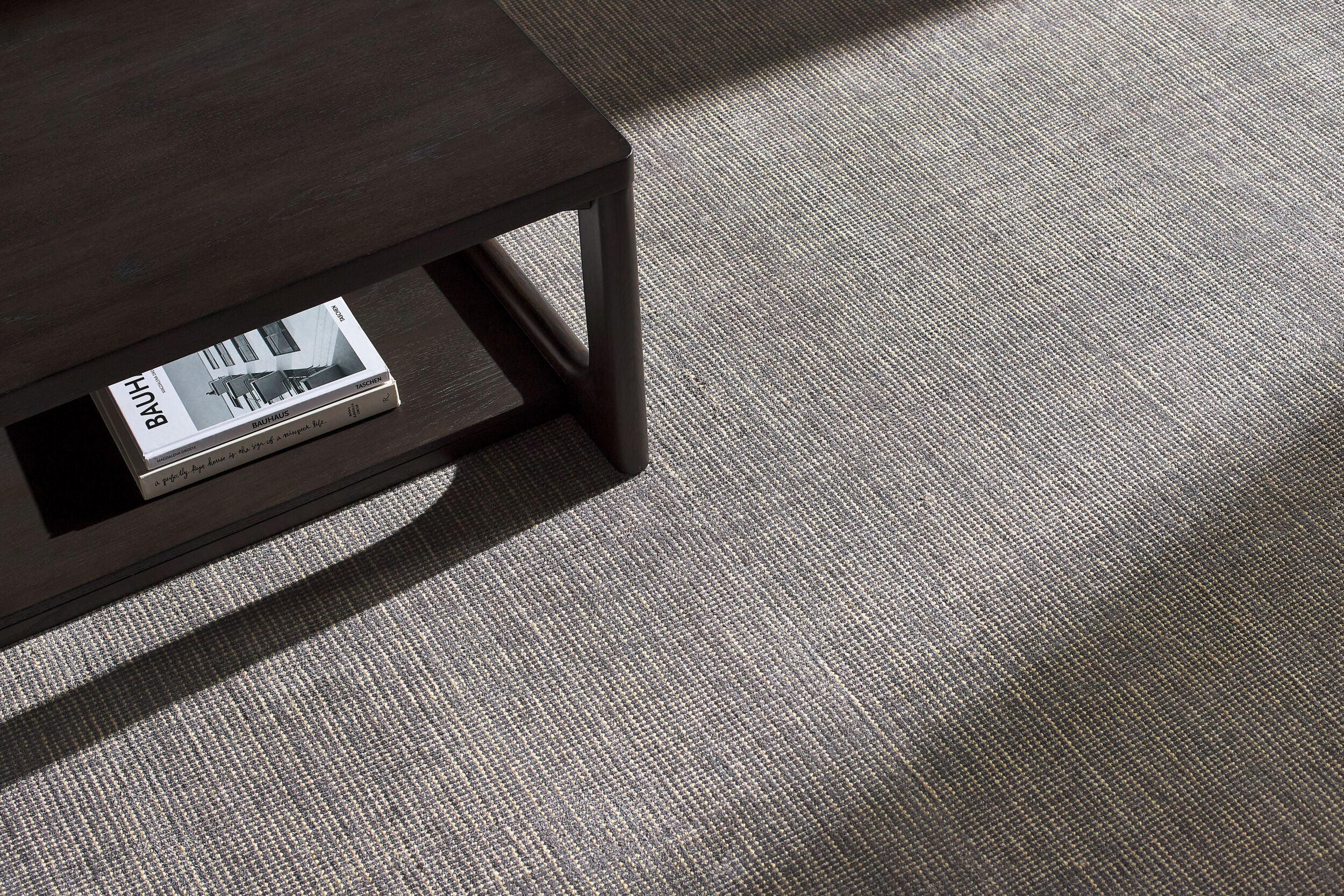 Neutral grey woven rug with subtle textured pattern and fringed edges