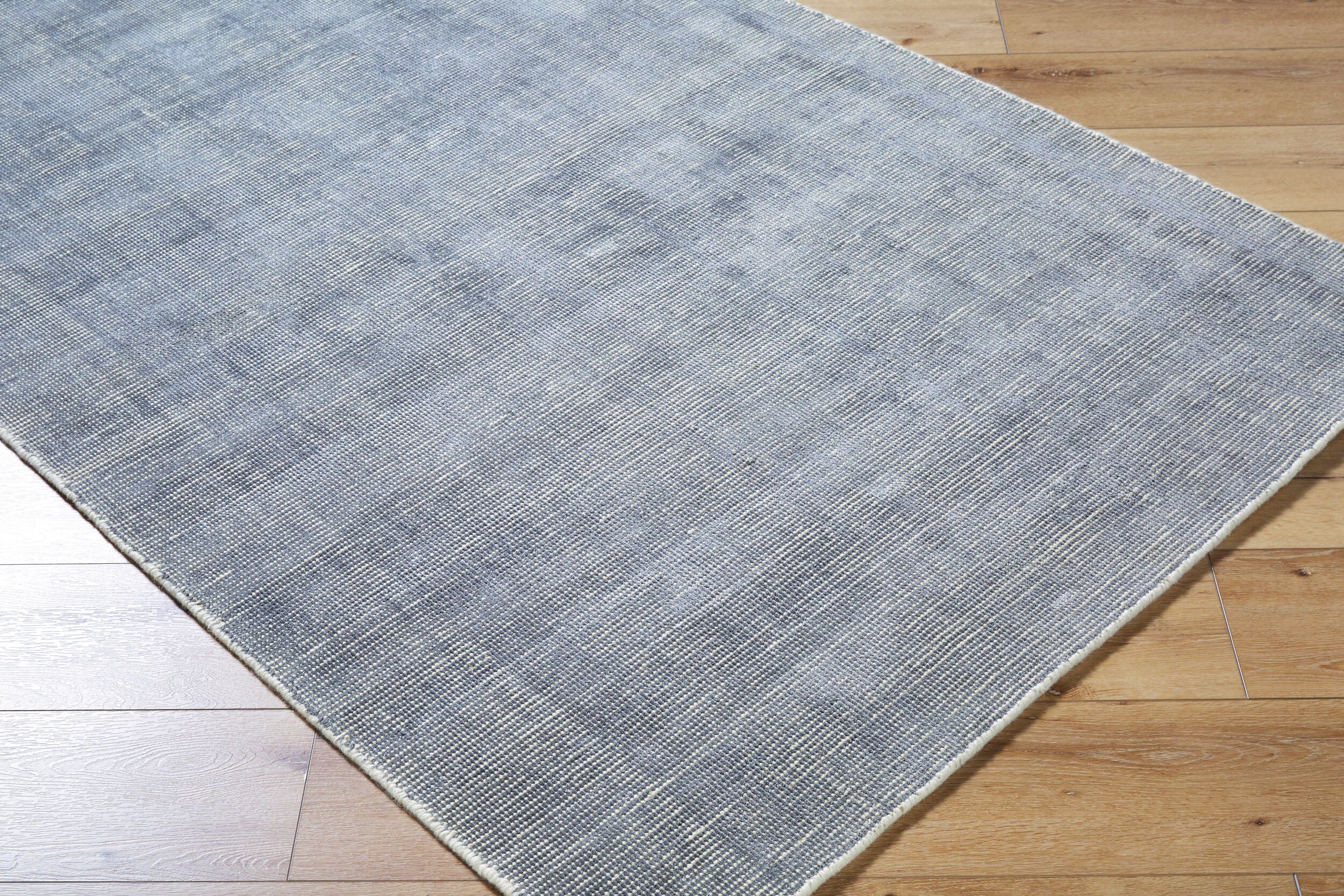 Gray and white textured area rug with subtle woven pattern design