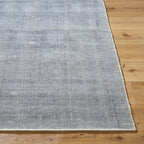 Gray and white textured area rug with subtle woven pattern design