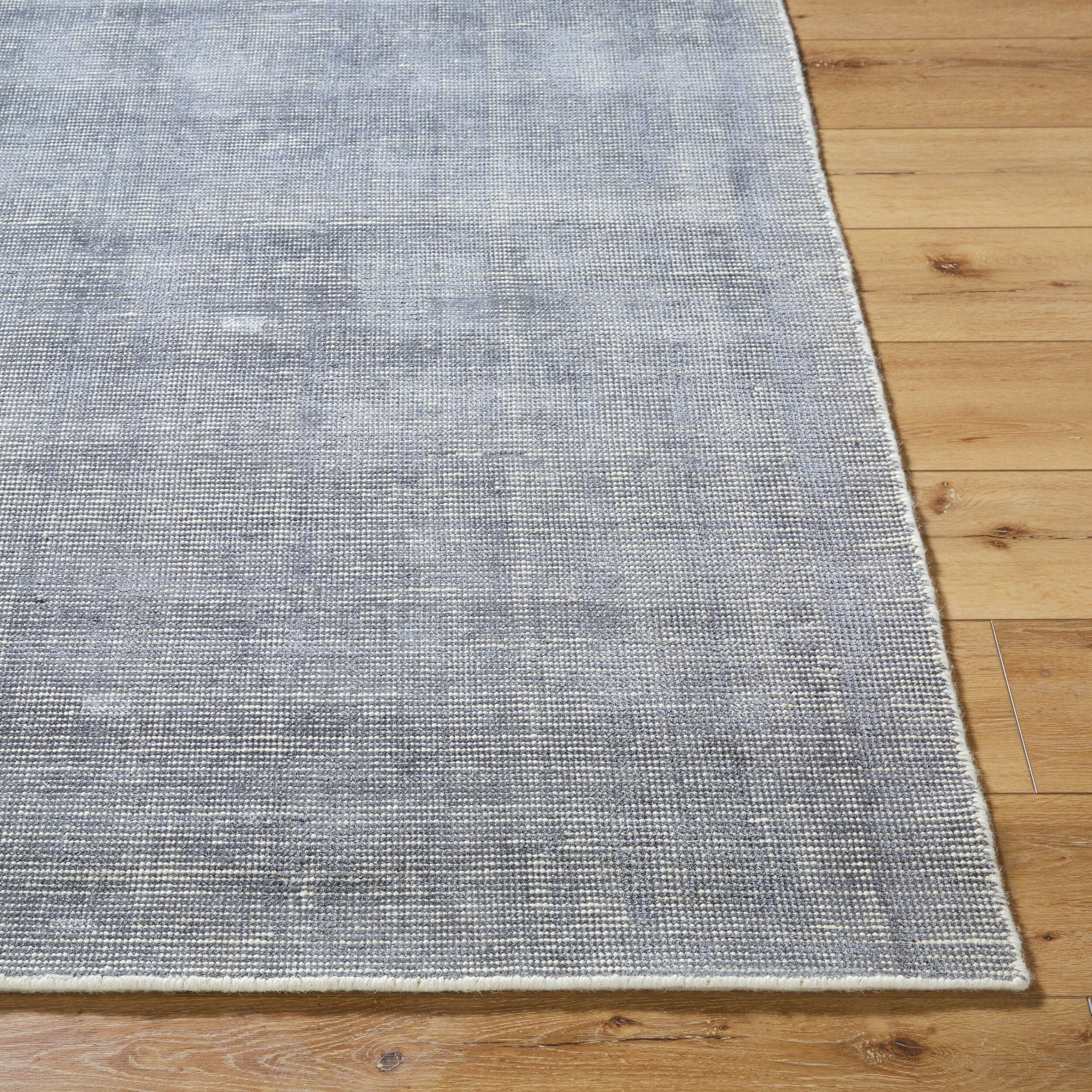 Gray and white textured area rug with subtle woven pattern design