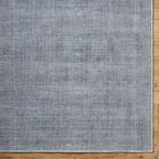 Gray and white textured area rug with subtle woven pattern design