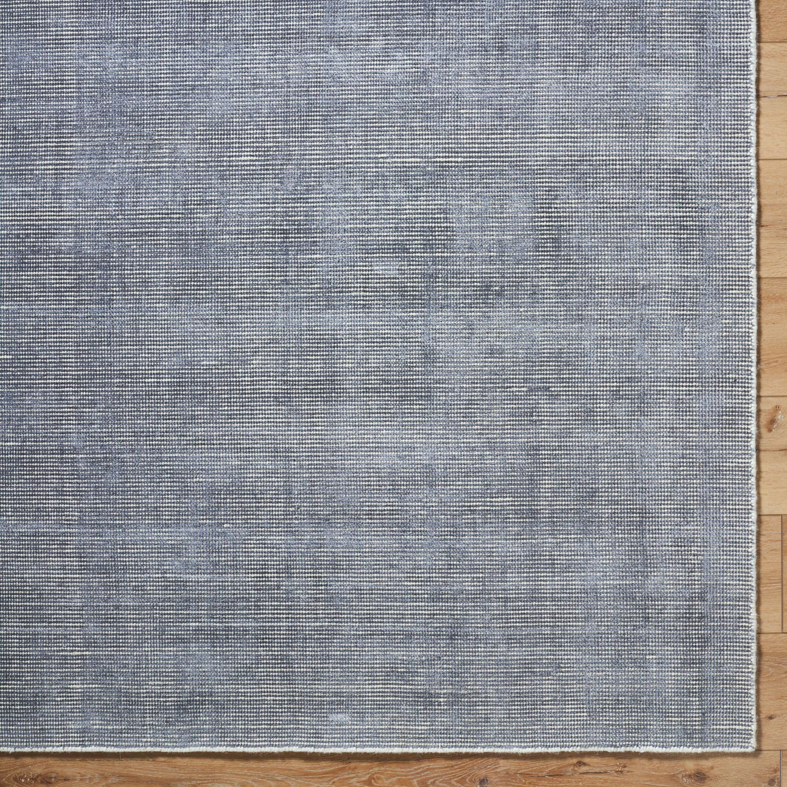 Gray and white textured area rug with subtle woven pattern design