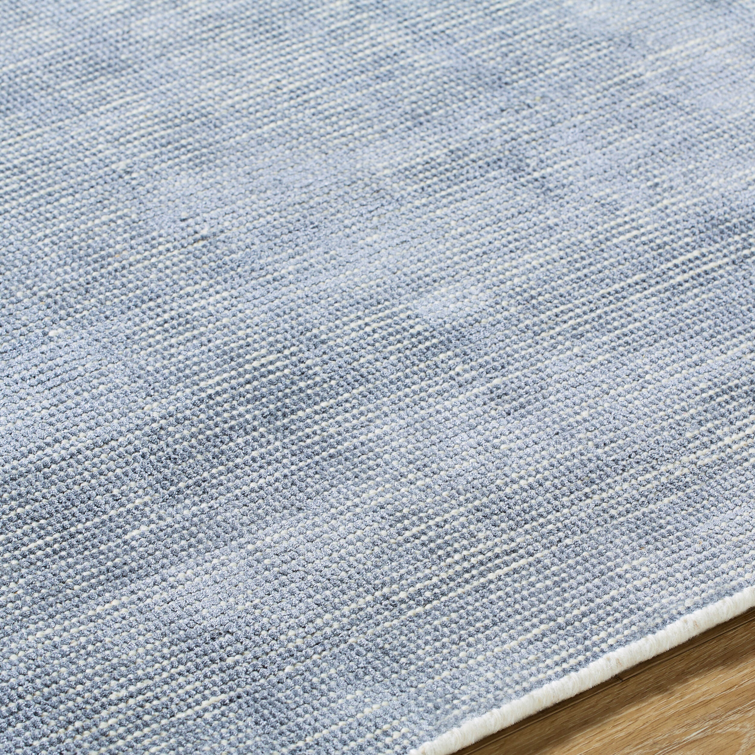 Gray and white textured area rug with subtle woven pattern design