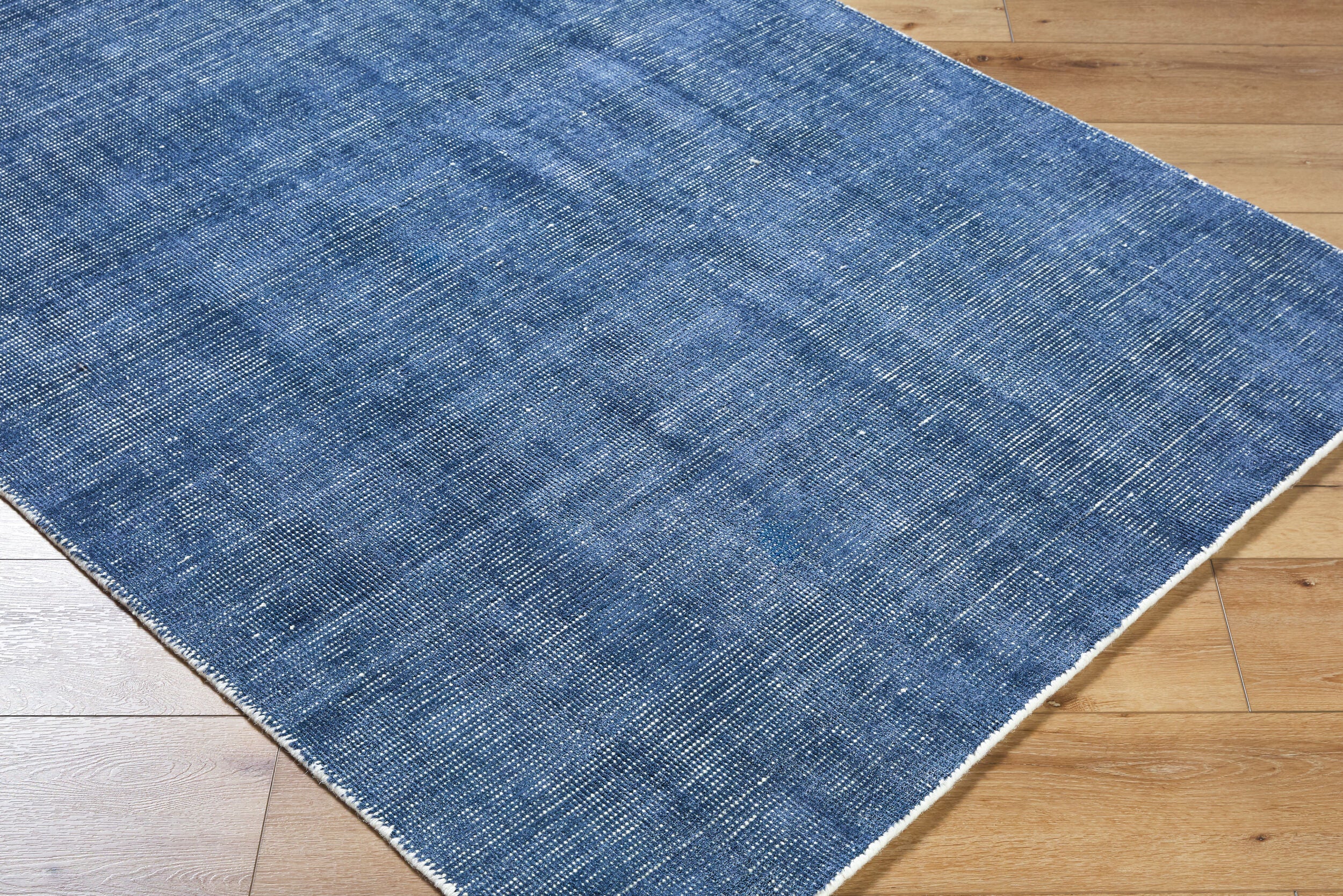 Blue textured area rug with subtle striped pattern and natural woven appearance