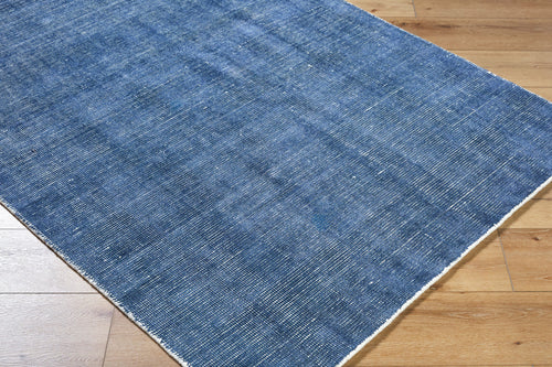 Blue textured area rug with subtle striped pattern and natural woven appearance