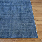 Blue textured area rug with subtle striped pattern and natural woven appearance
