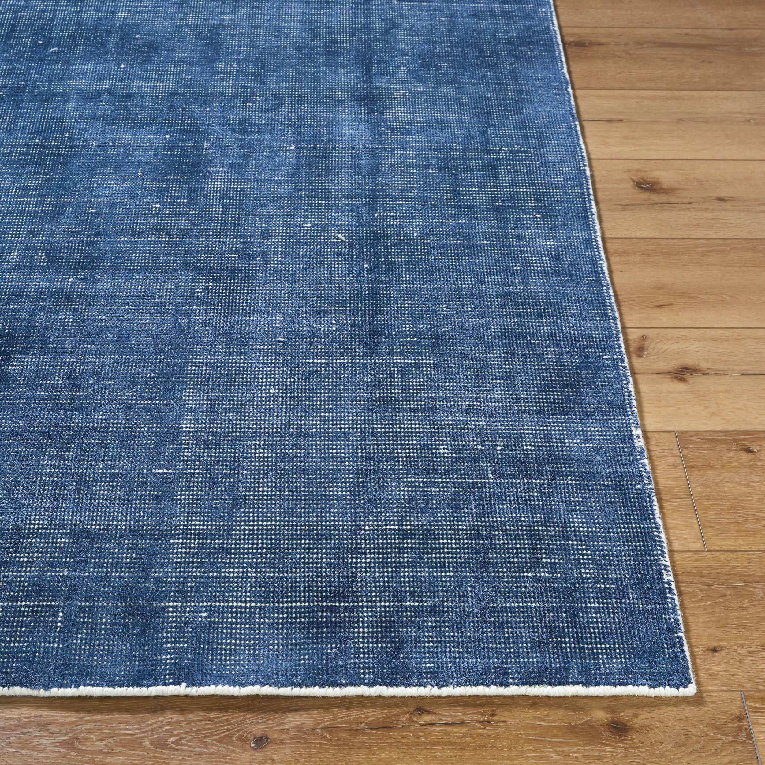 Blue textured area rug with subtle striped pattern and natural woven appearance