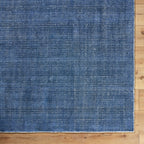 Blue textured area rug with subtle striped pattern and natural woven appearance