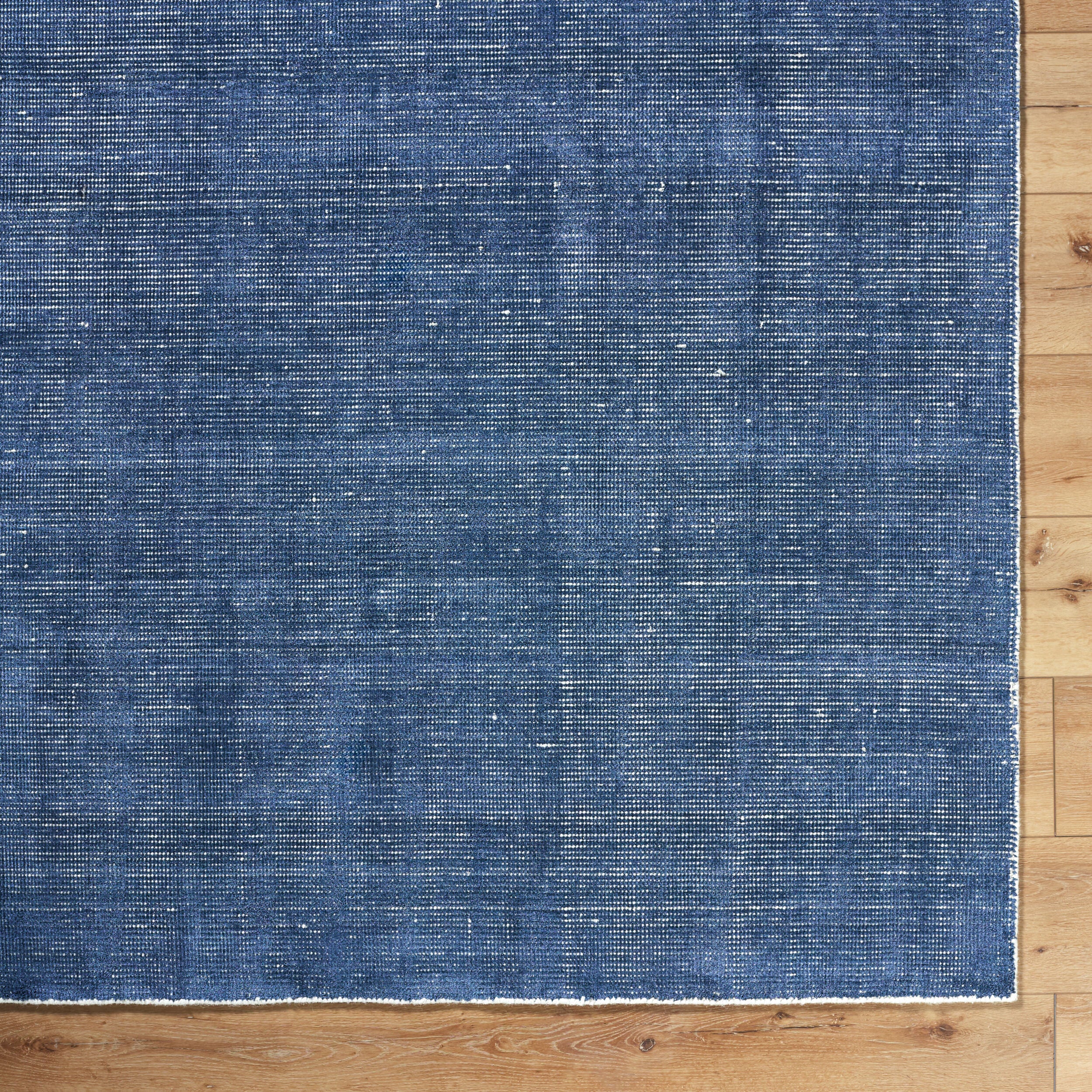 Blue textured area rug with subtle striped pattern and natural woven appearance