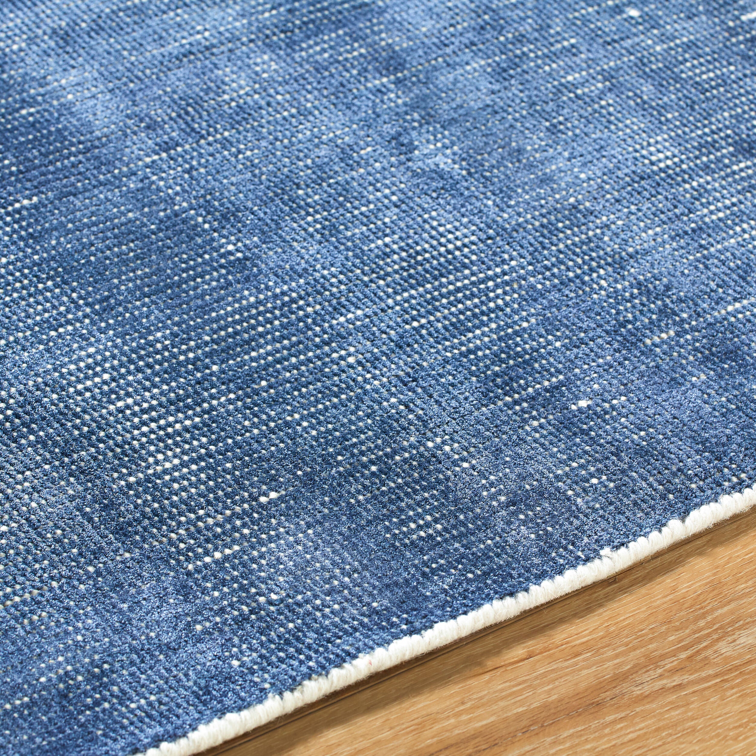 Blue textured area rug with subtle striped pattern and natural woven appearance
