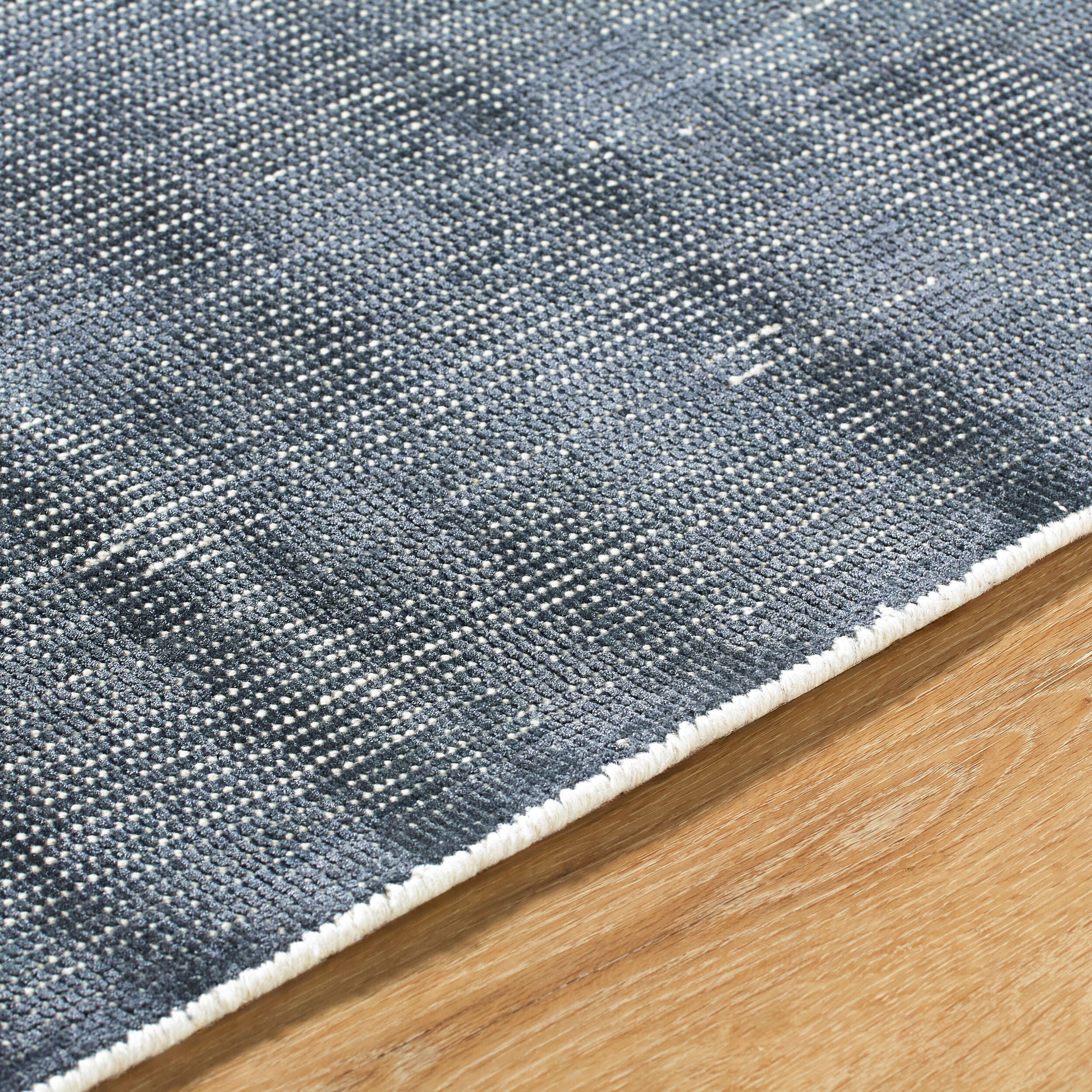 Modern gray textured area rug with woven striped pattern throughout