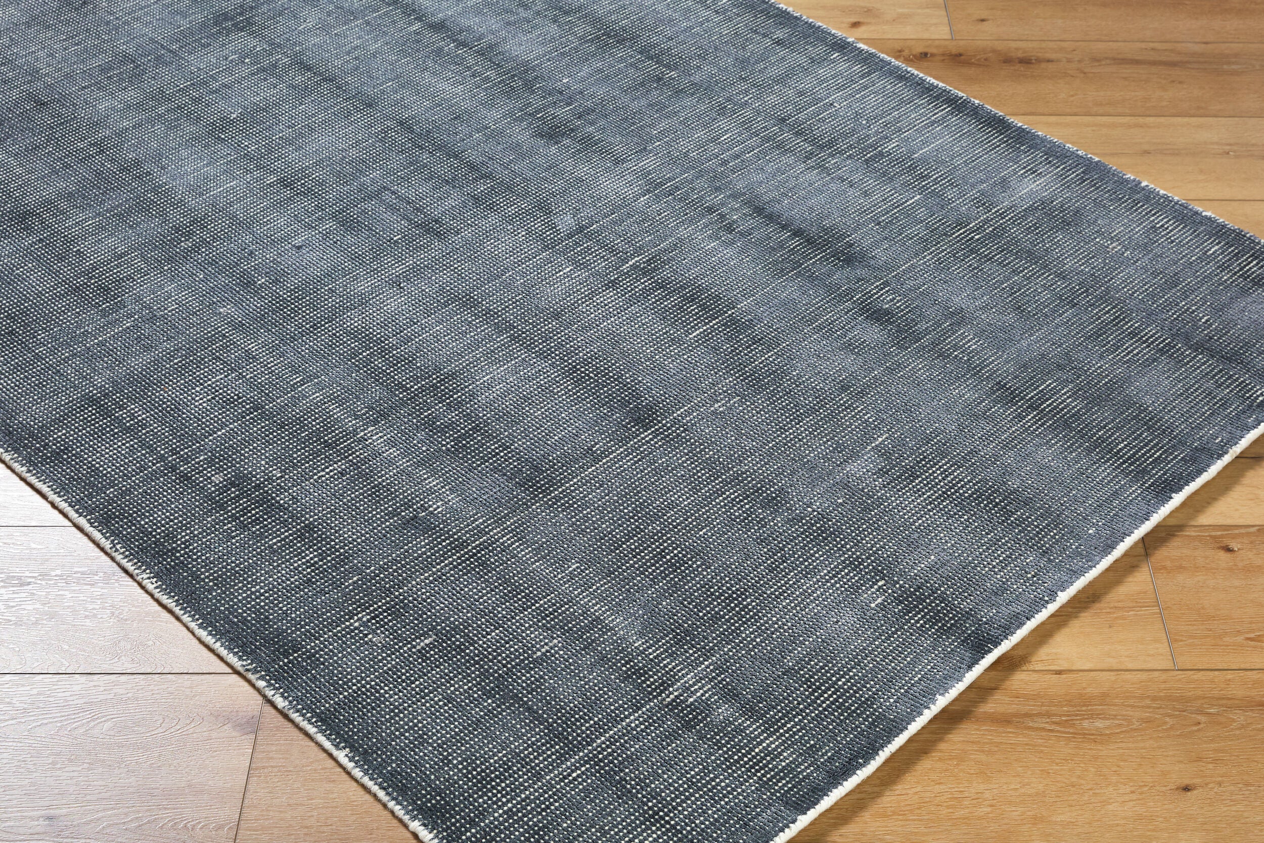 Modern gray textured area rug with woven striped pattern throughout