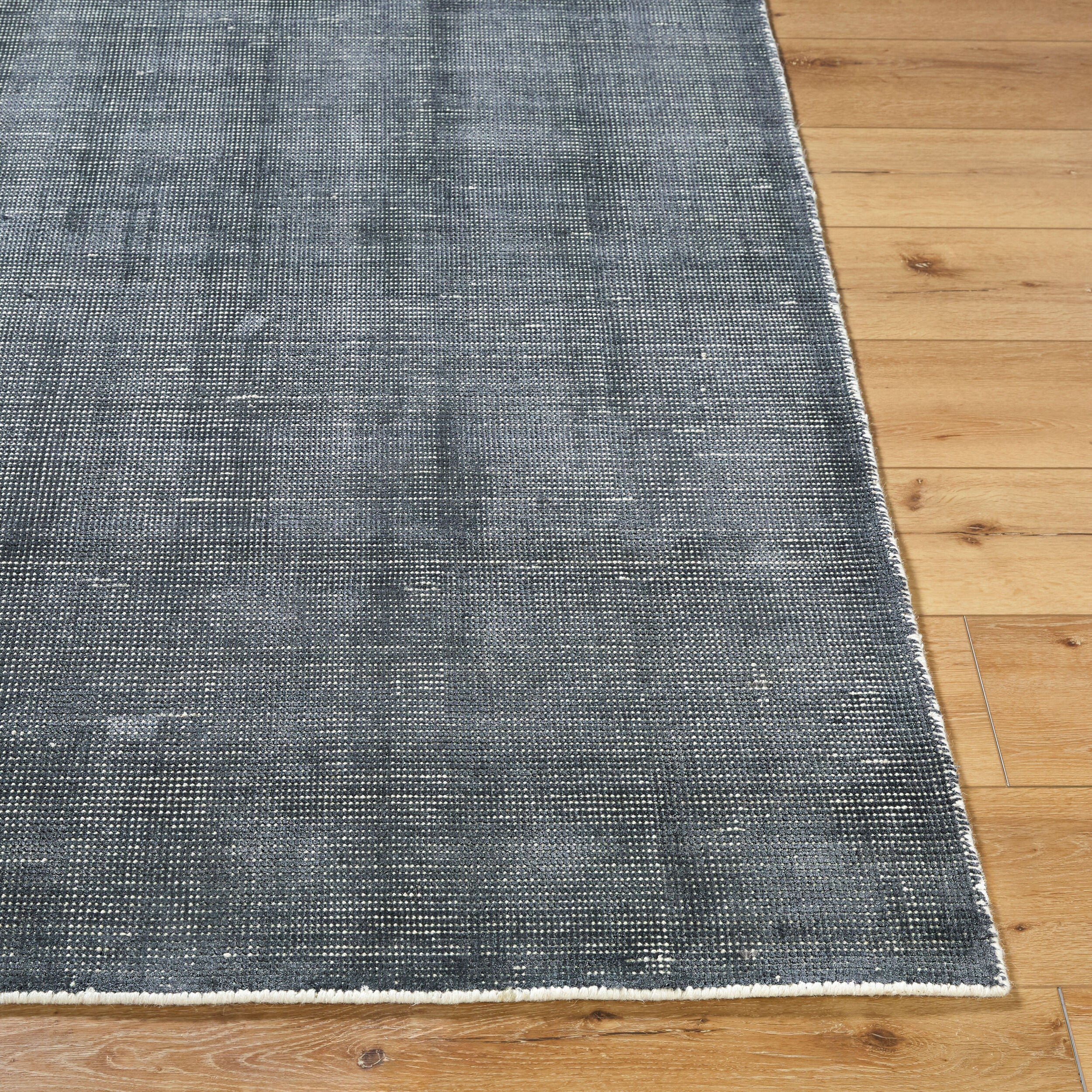 Modern gray textured area rug with woven striped pattern throughout