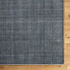 Modern gray textured area rug with woven striped pattern throughout