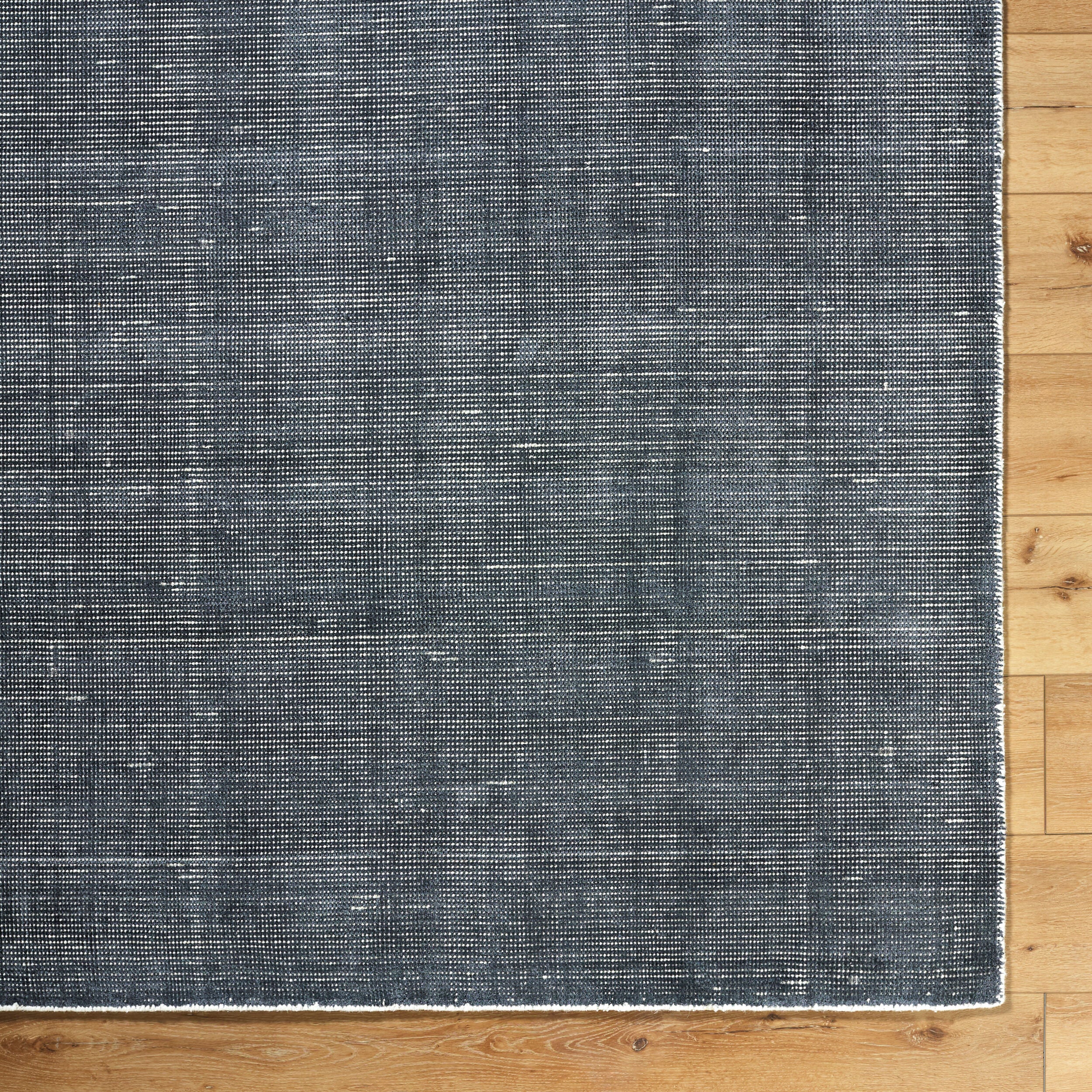 Modern gray textured area rug with woven striped pattern throughout