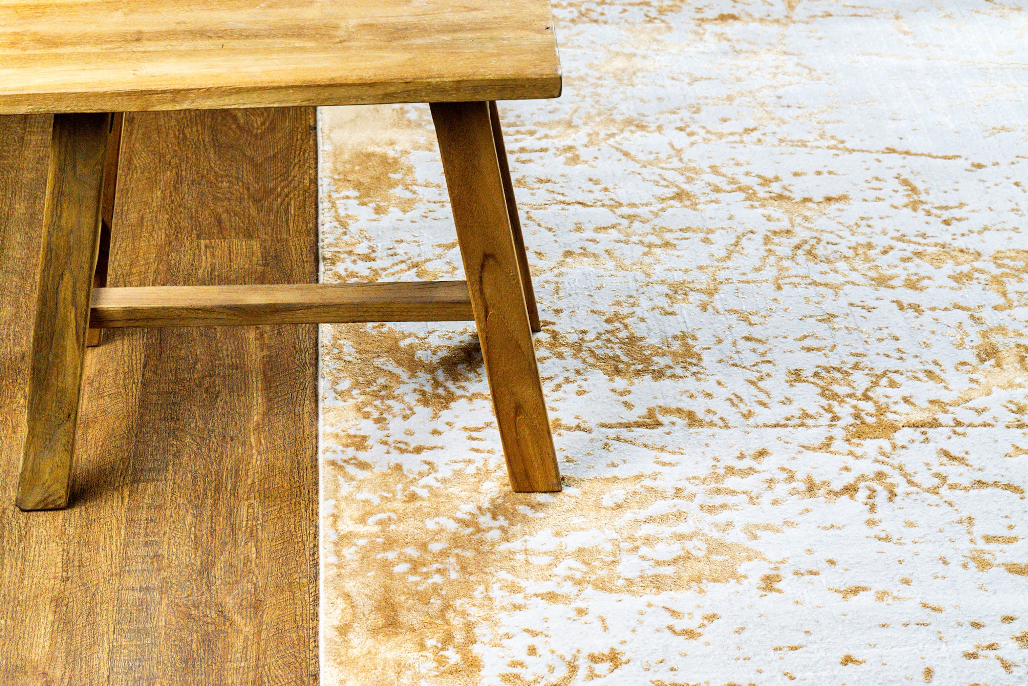 Gold and cream distressed texture rug with abstract weathered pattern