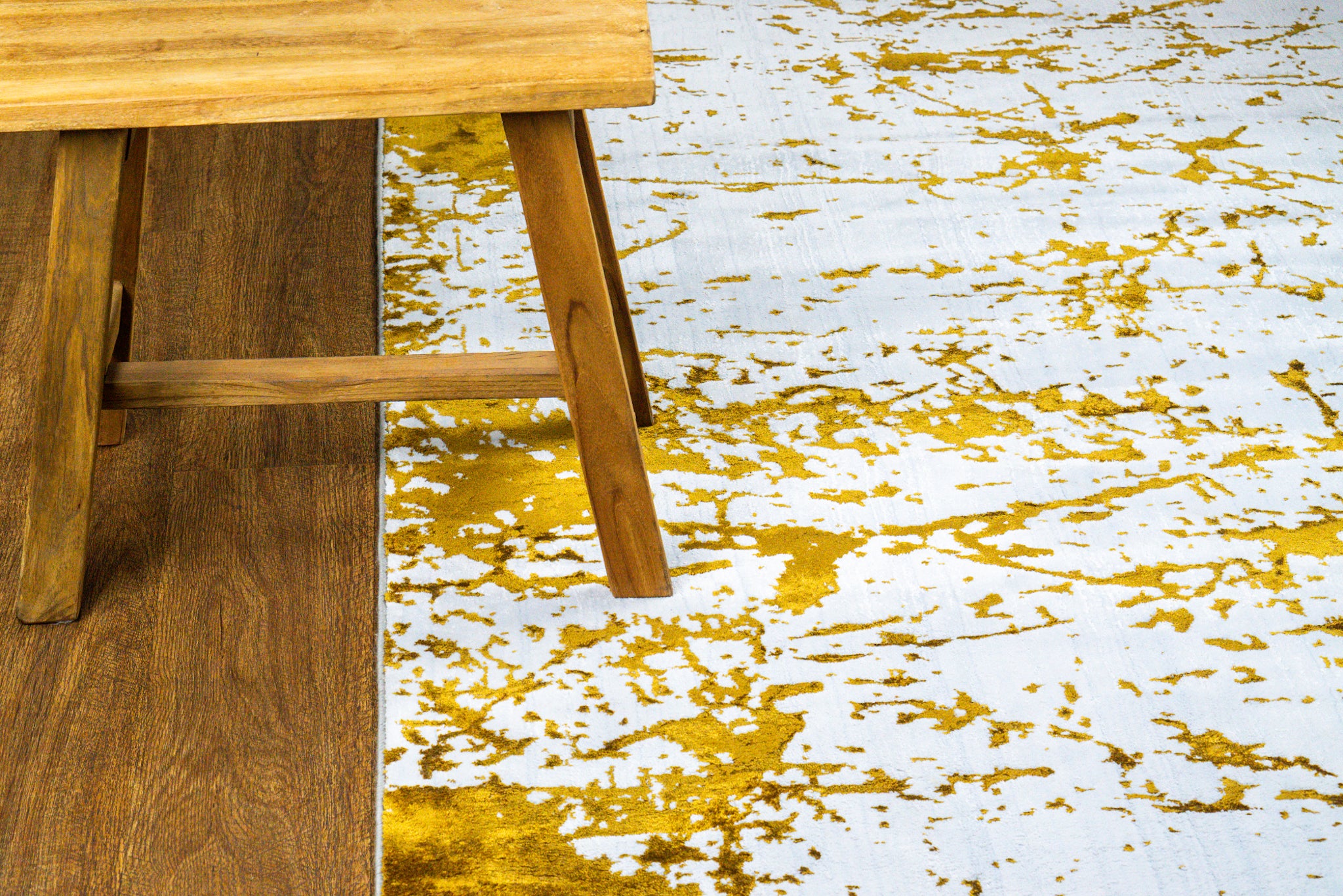 Distressed white and gold rug with splattered paint effect texture