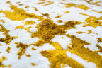 Distressed white and gold rug with splattered paint effect texture