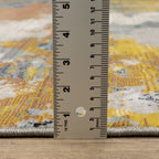 Abstract distressed rug with yellow, blue, and cream paint splatter pattern design
