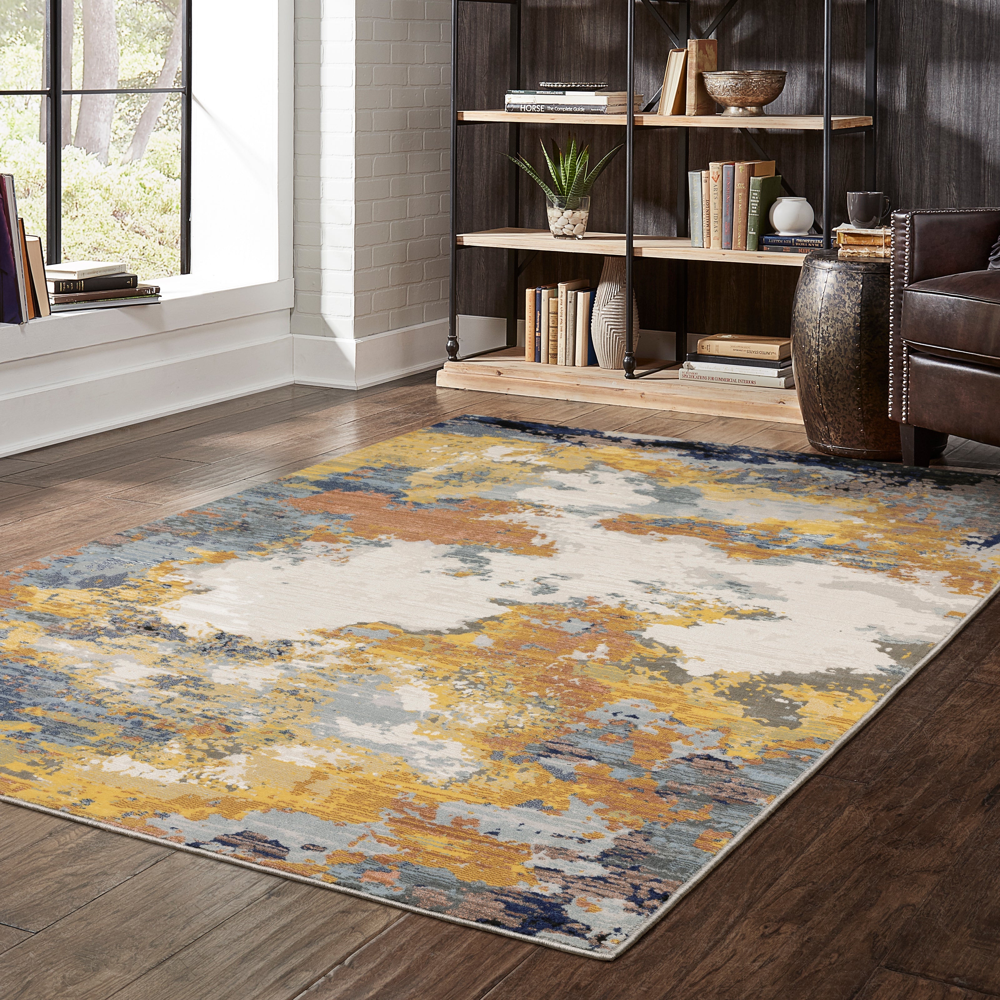 Abstract distressed rug with yellow, blue, and cream paint splatter pattern design