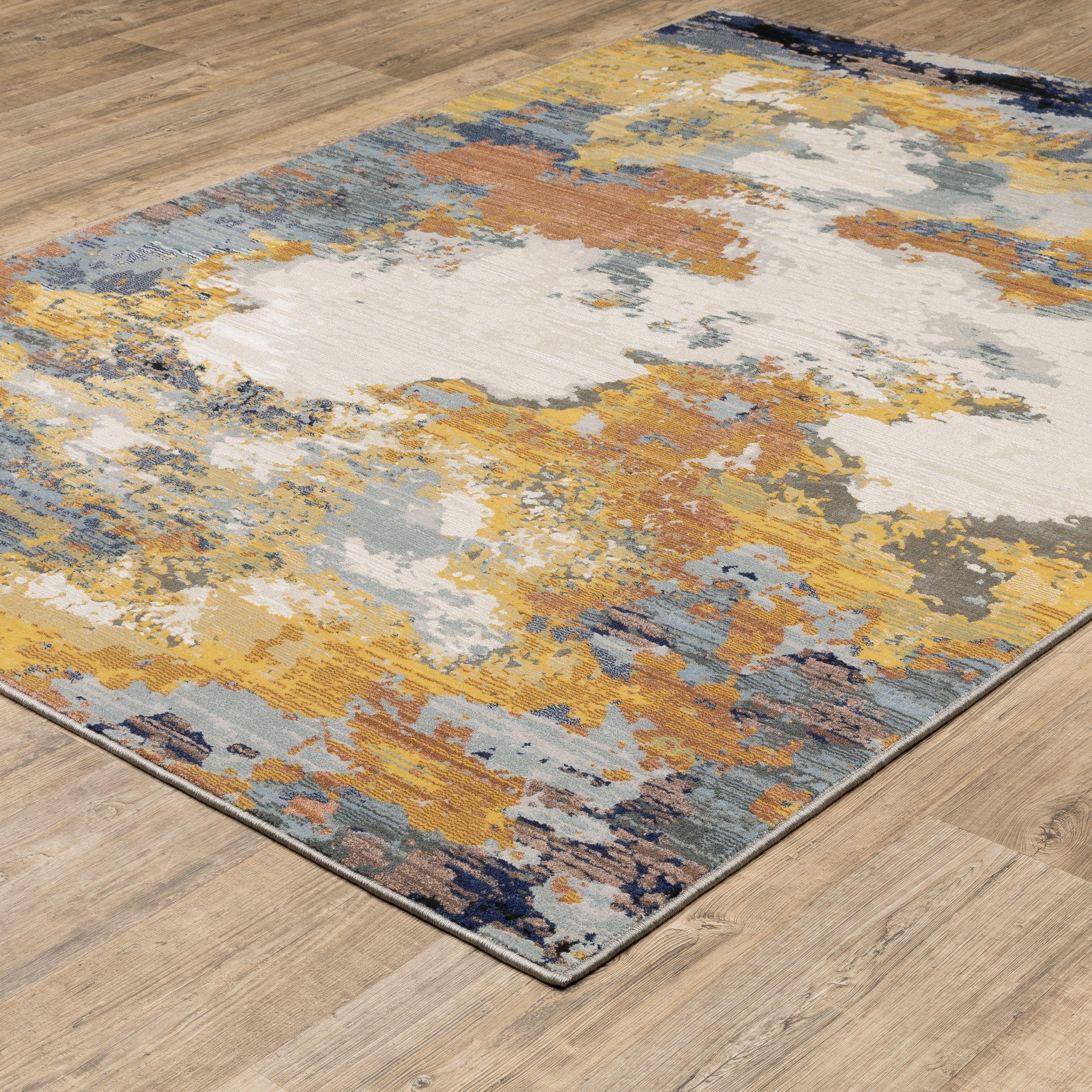 Abstract distressed rug with yellow, blue, and cream paint splatter pattern design