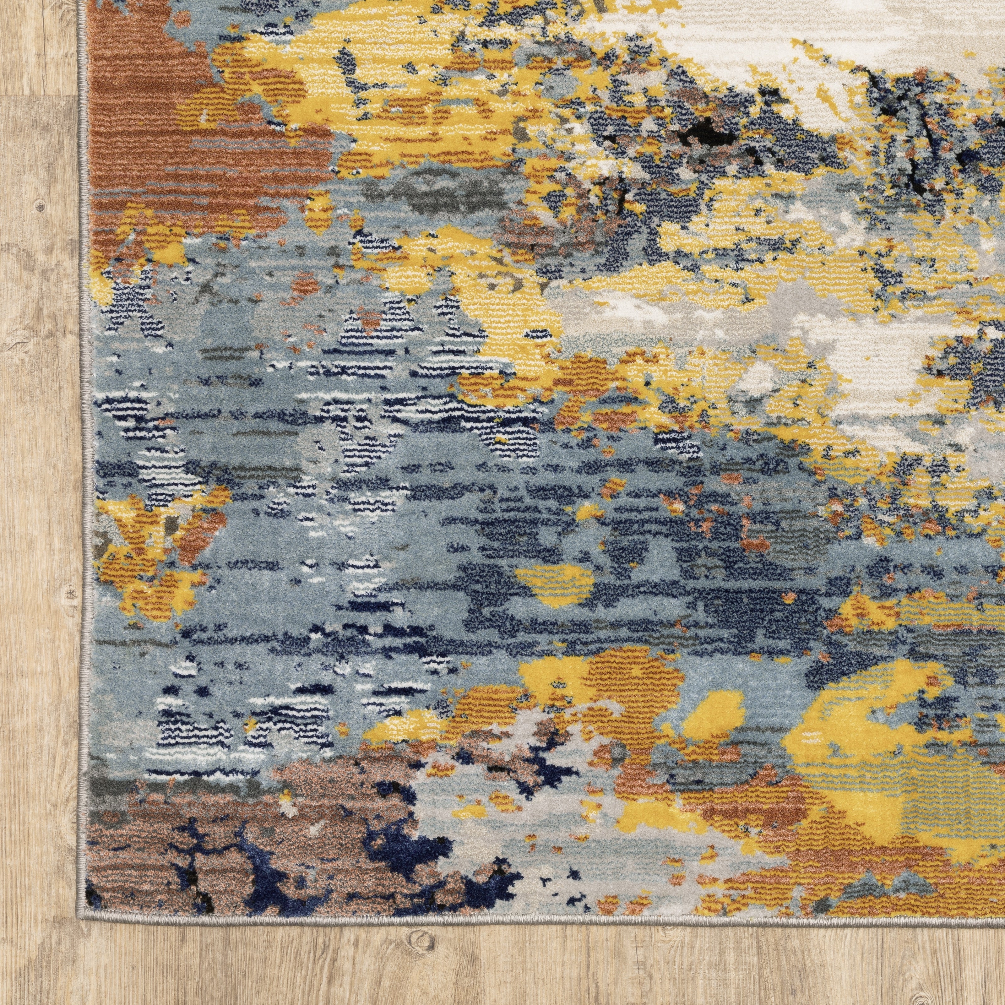 Abstract distressed rug with yellow, blue, and cream paint splatter pattern design