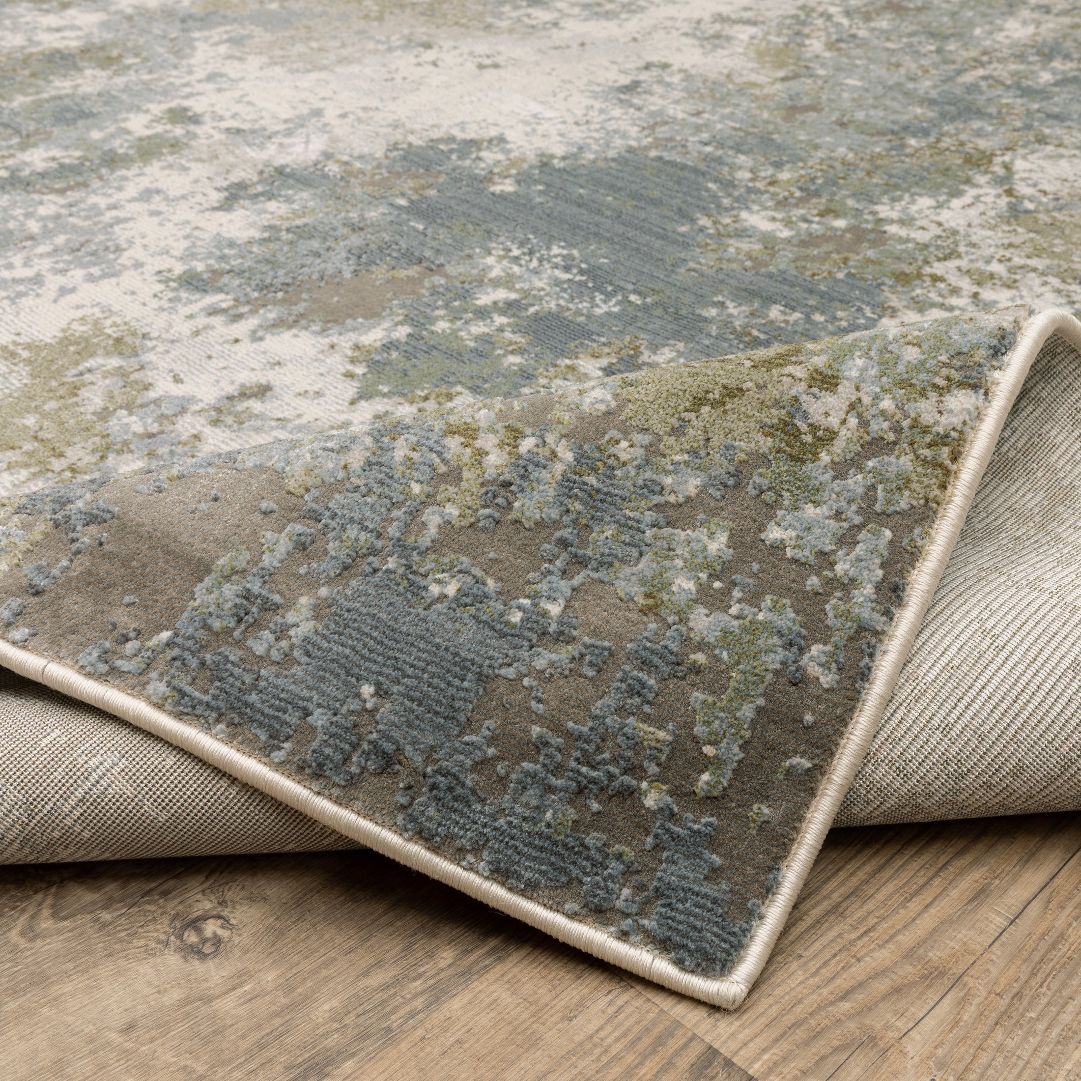 Modern distressed area rug with grey, cream, and olive abstract texture pattern