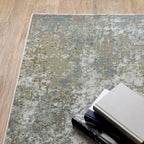 Modern distressed area rug with grey, cream, and olive abstract texture pattern