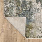 Modern distressed area rug with grey, cream, and olive abstract texture pattern