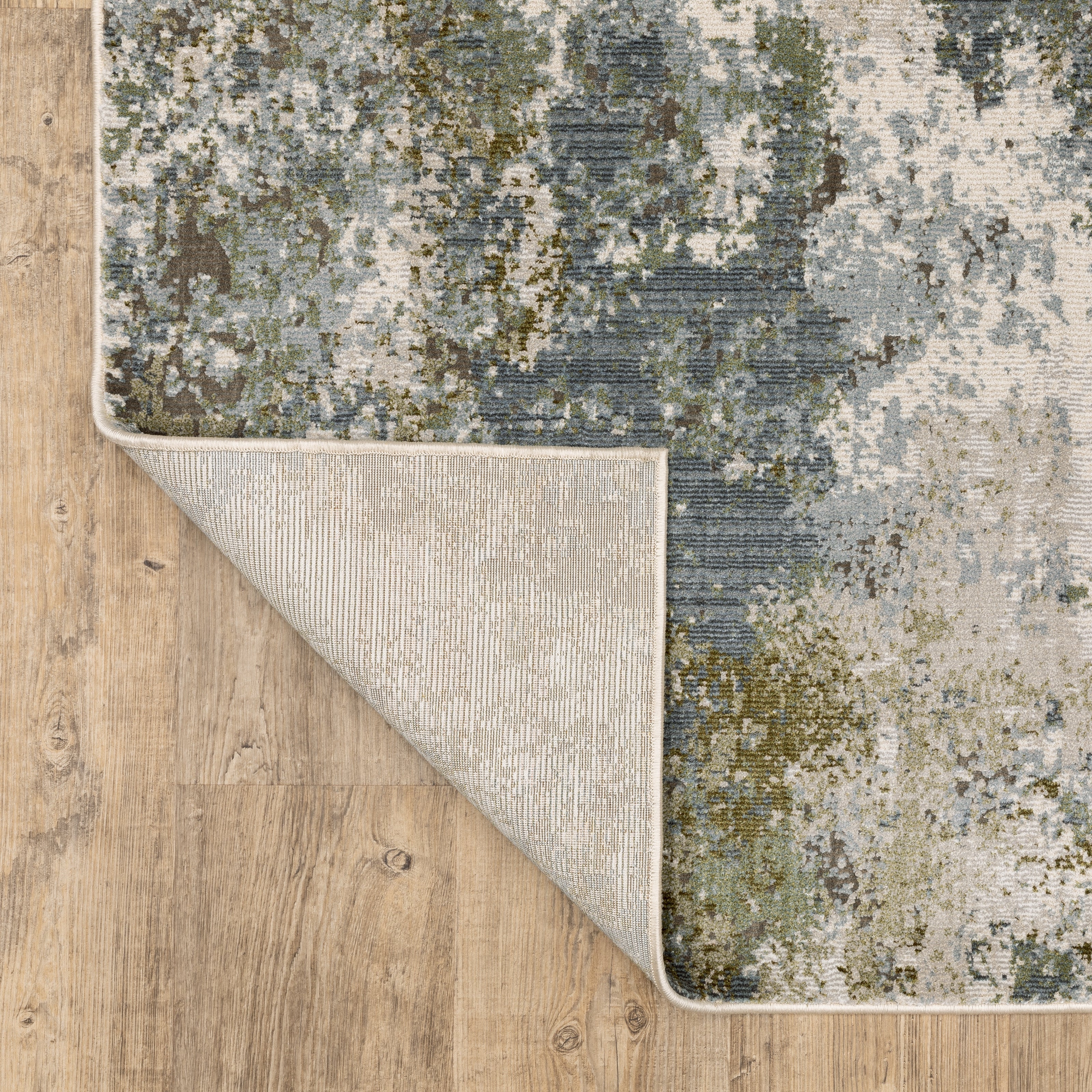 Modern distressed area rug with grey, cream, and olive abstract texture pattern