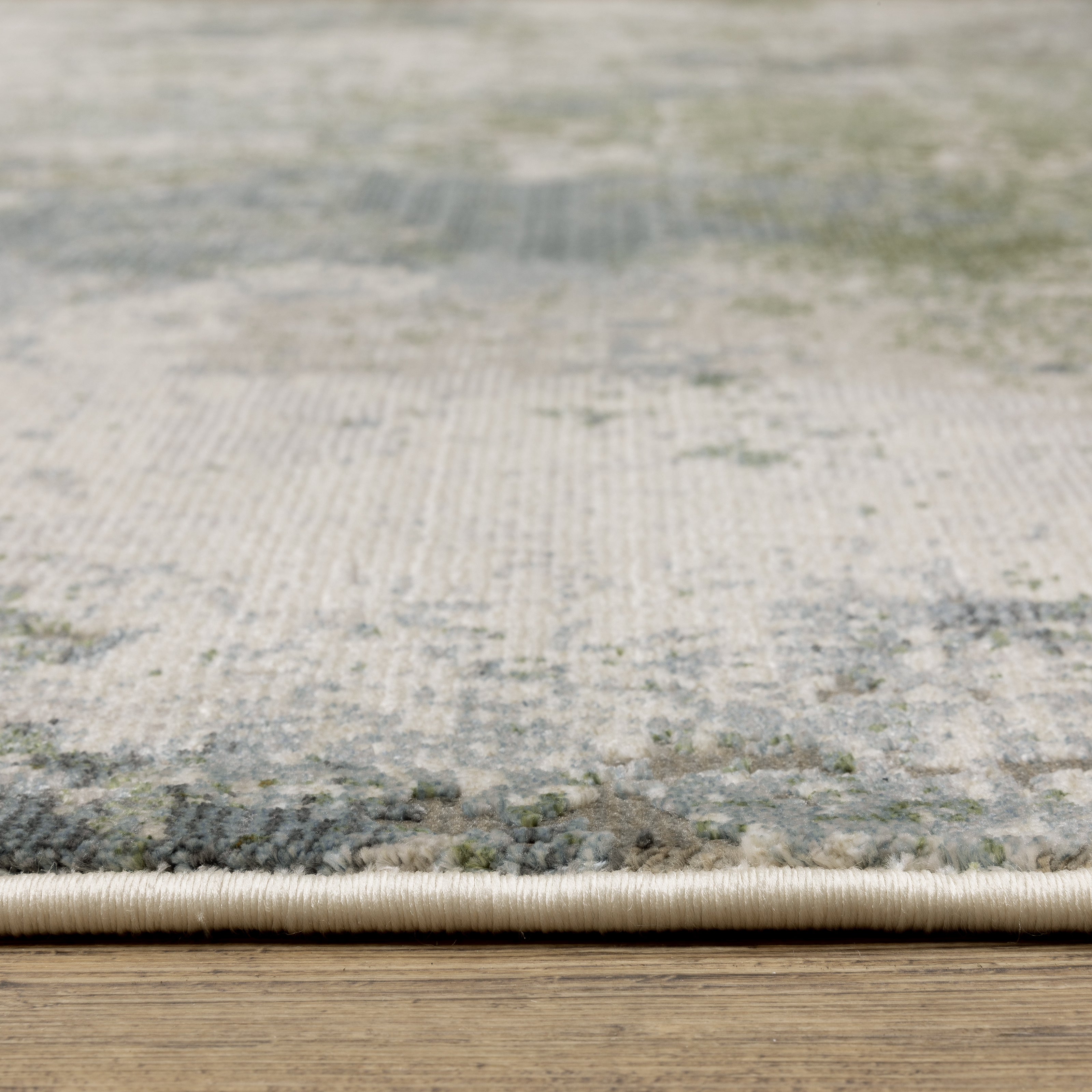 Modern distressed area rug with grey, cream, and olive abstract texture pattern