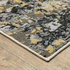 Abstract distressed rug with gold, black, and cream tones, worn texture design