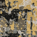 Abstract distressed rug with gold, black, and cream tones, worn texture design