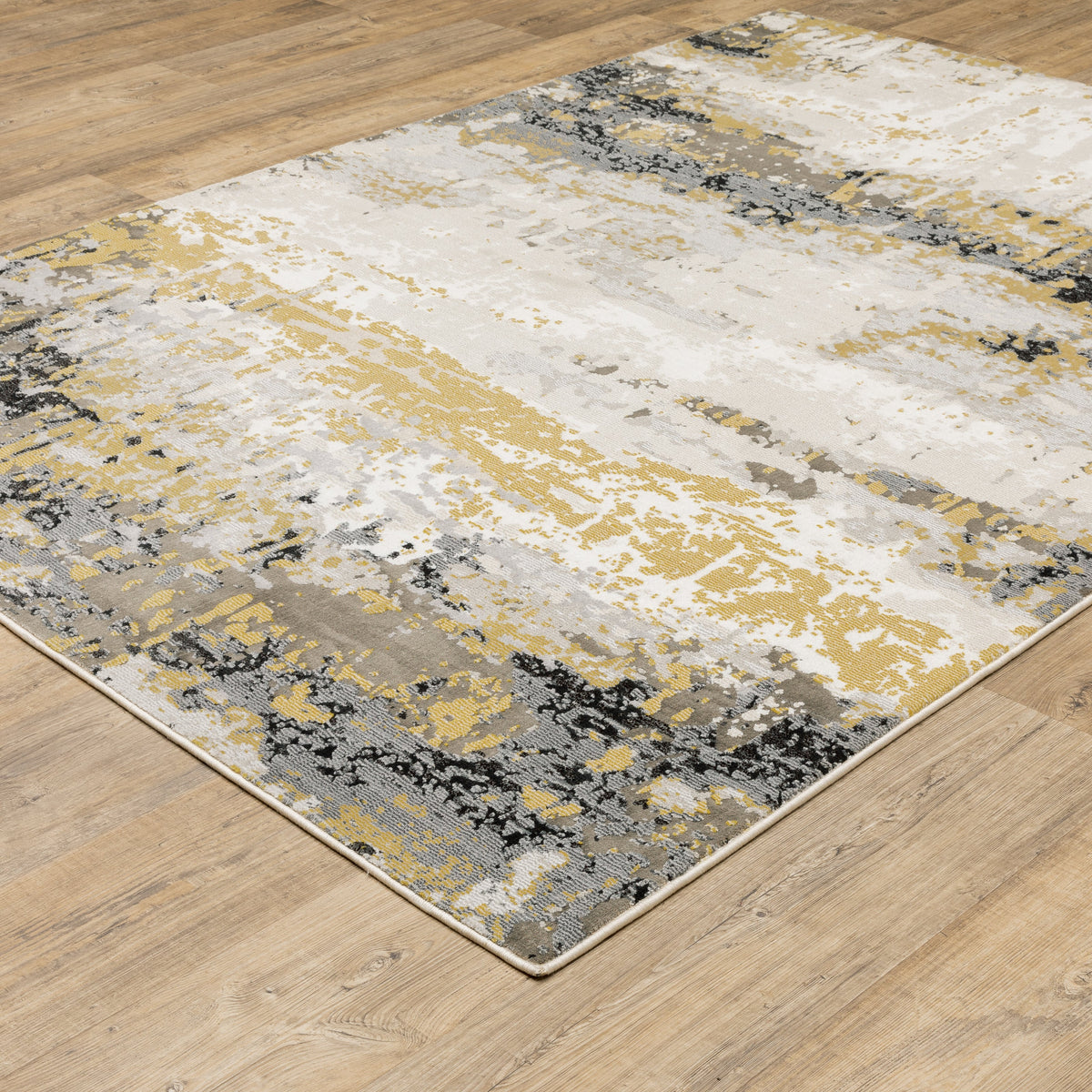 Abstract distressed rug with gold, black, and cream tones, worn texture design