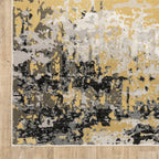 Abstract distressed rug with gold, black, and cream tones, worn texture design