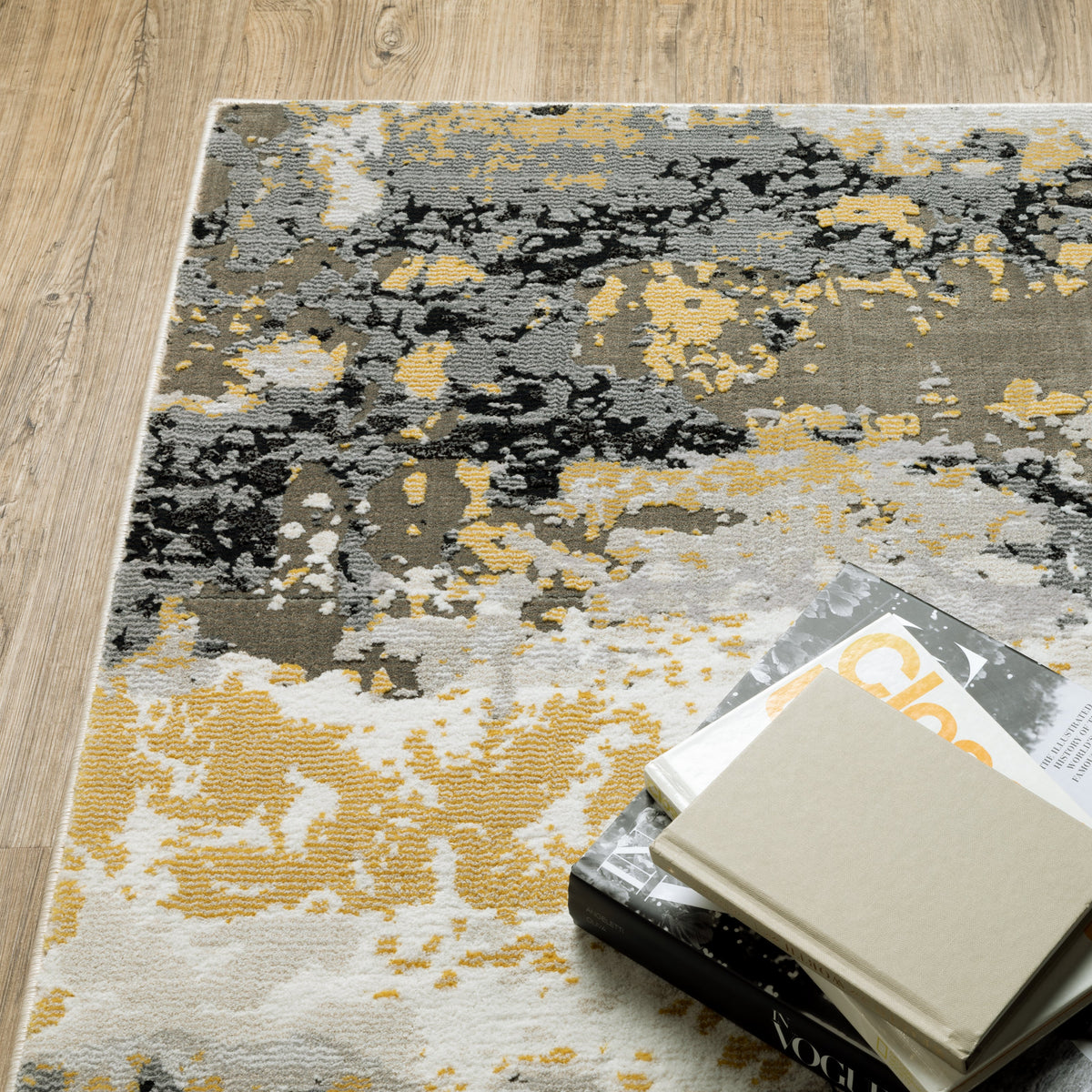 Abstract distressed rug with gold, black, and cream tones, worn texture design